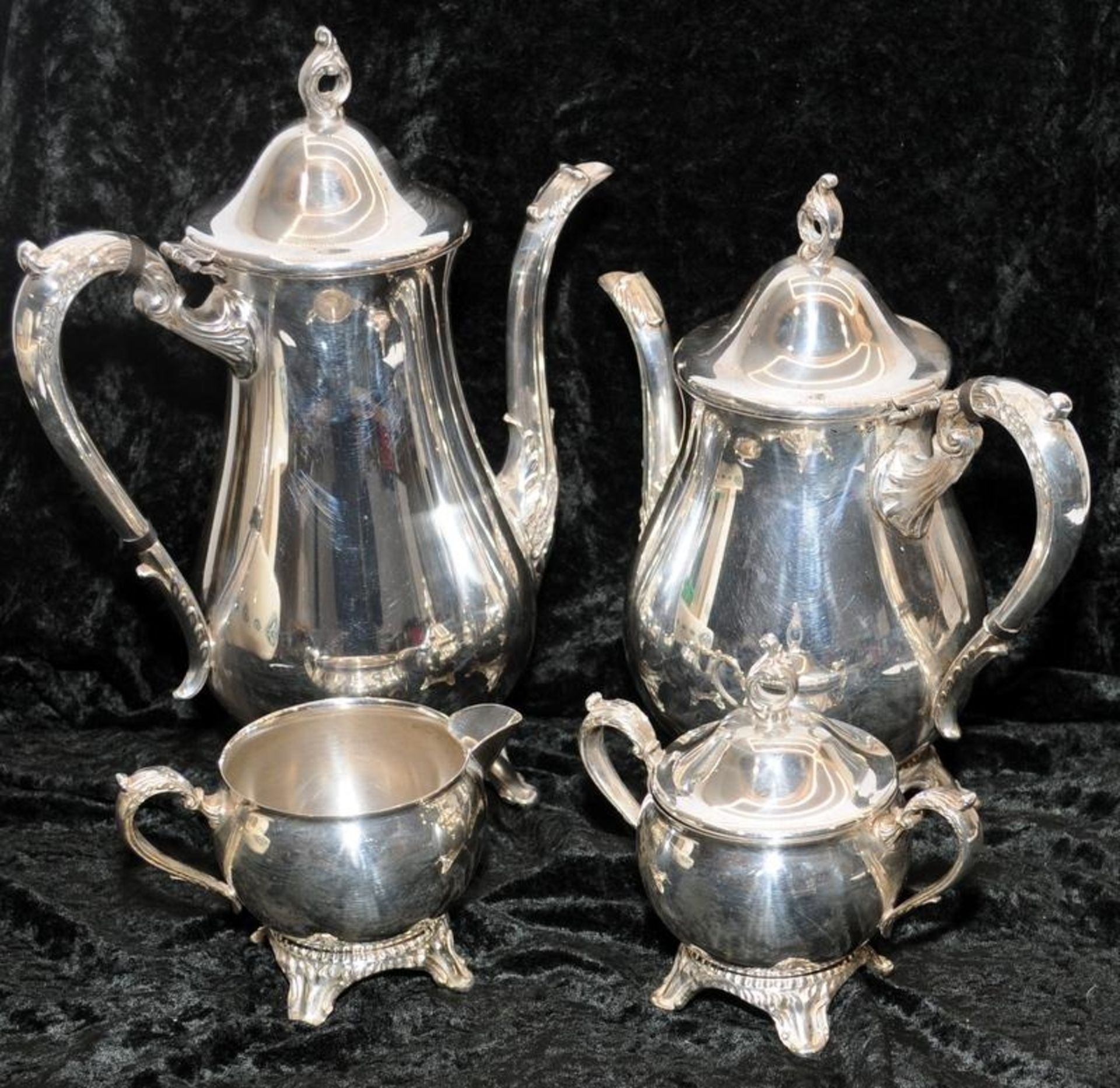 Matching silver plated tea and coffee pots with creamer and sugar bowl