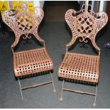 Pair of antique cast iron folding garden chairs. Possibly French.