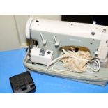 A Necchi sewing machine in case.