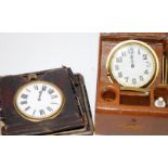 Two antique manual wind travel clocks