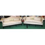 Two camel back sofas in a patterned upholstery each 90x215x90cm.