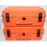 Two large orange peli-cases with foam interior. 54cms x 42cms x 21cms