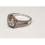 A 925 silver and CZ halo style ring Size P