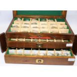 Watchmakers wooden worktop cabinet consisting hinged compartmentalised shelf over two drawers.