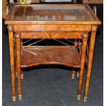 A Neoclassical style burr walnut veneer table featuring classical tapered legs with brass feet and