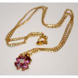 9ct gold four leaf clover pendant comprising diamonds and pink sapphires on an 18" 9ct gold chain.