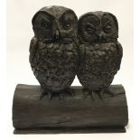 Bronzed resin model of two large owls on a tree stump 46cm tall.