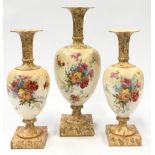 Set of three floral painted porcelain vases the largest measuring 31.5cm tall.