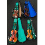 Four violins in cases for restoration.