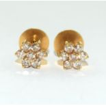 Diamond Daisy earrings set in 18ct gold mounts.