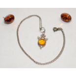 Boxed Baltic amber pendant and earrings.