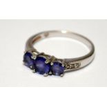 A 925 silver three stone amethyst ring Size N.