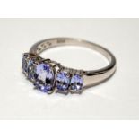 A 925 silver and five stone tanzanite ring Size P