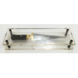 A decorative dagger in perspex case.