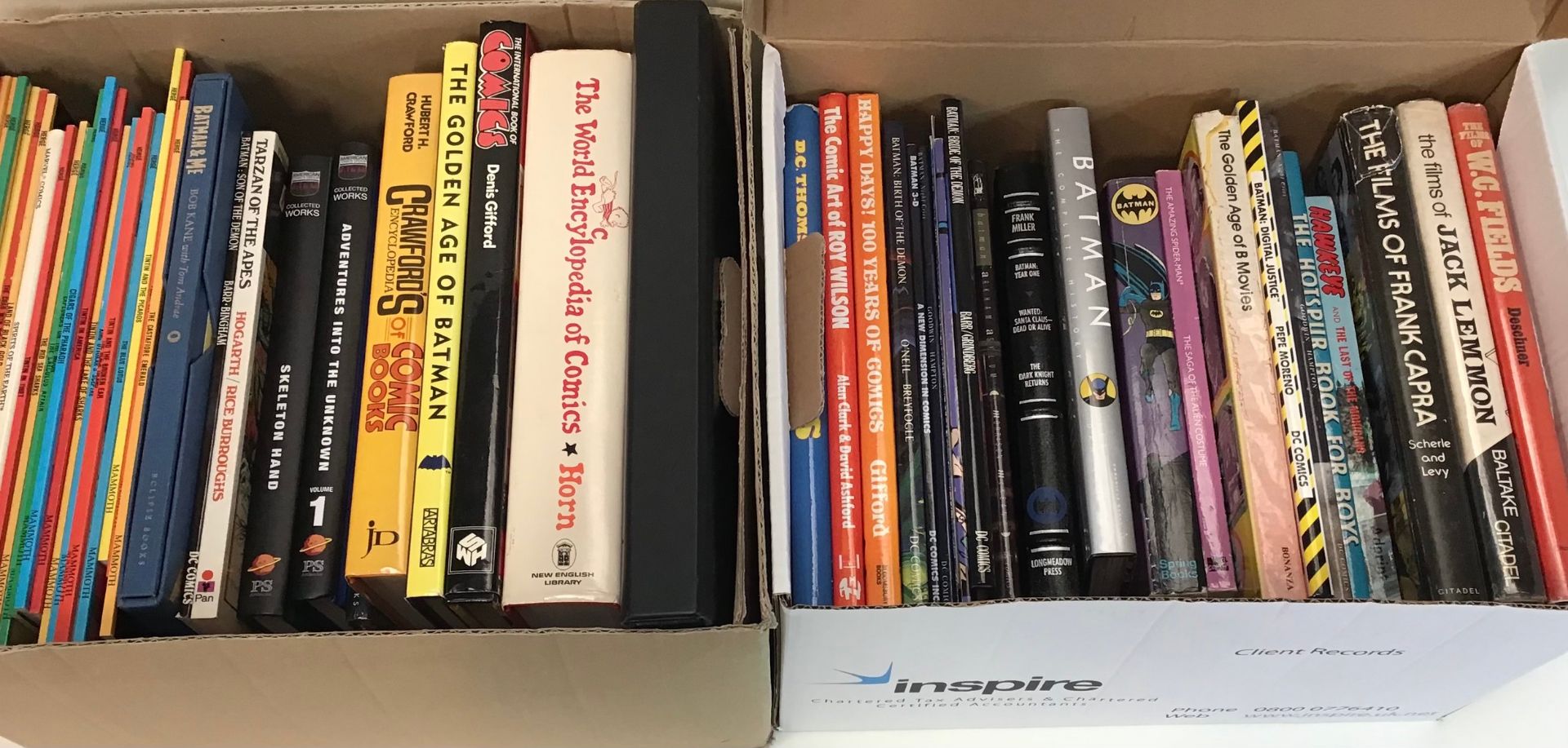 2 boxes containing a quantity of soft and hardback books relating to comics, film stars and comic