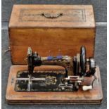 Antique Frister & Rossmann sewing machine in wooden case.