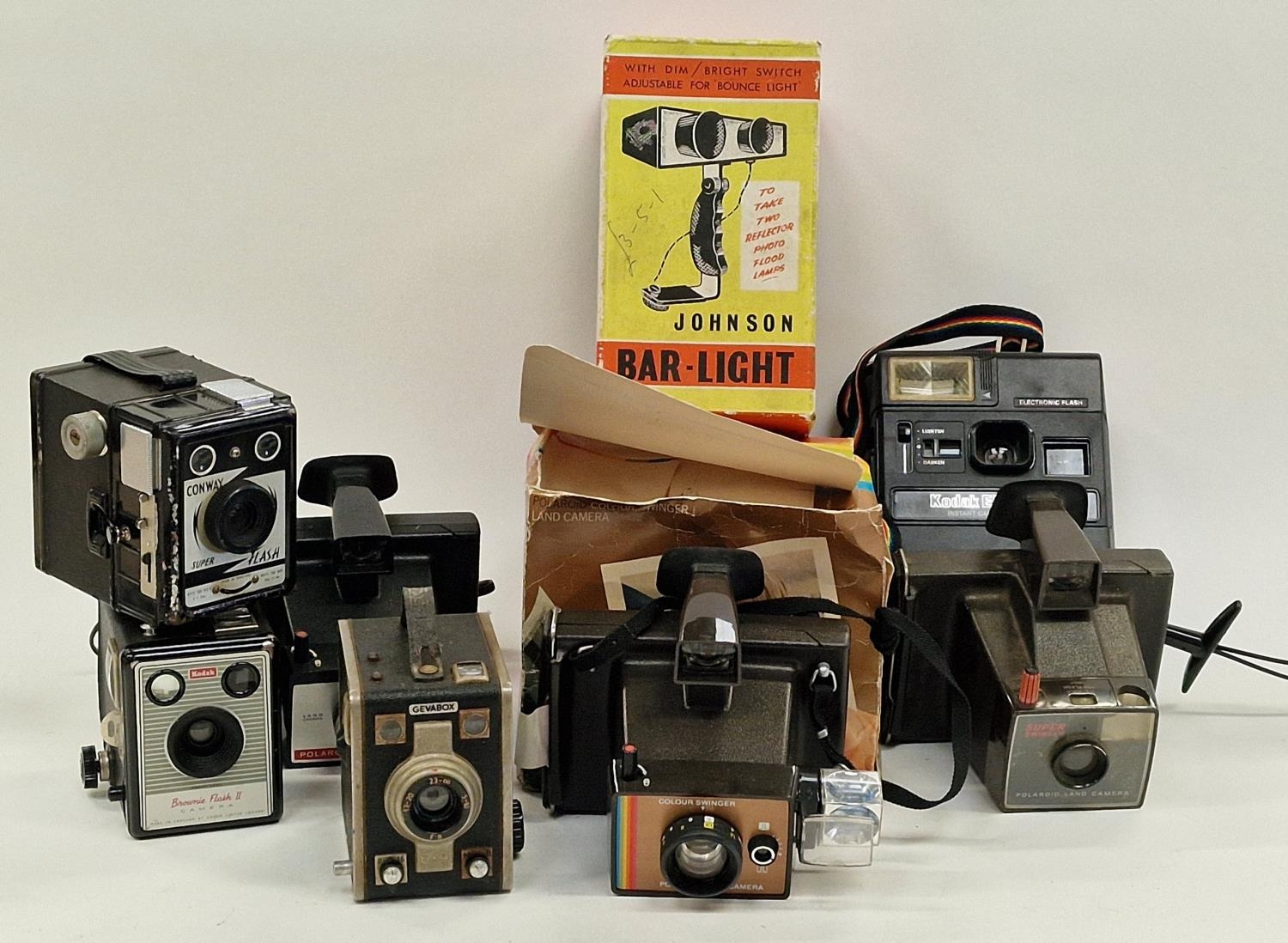 Collection of vintage cameras and equipment to include Polaroid instant cameras.