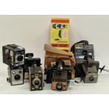Collection of vintage cameras and equipment to include Polaroid instant cameras.