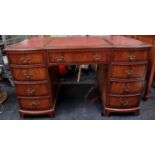 Twin pedestal desk with tooled leather inset top above nine drawers 76x122x60cm.