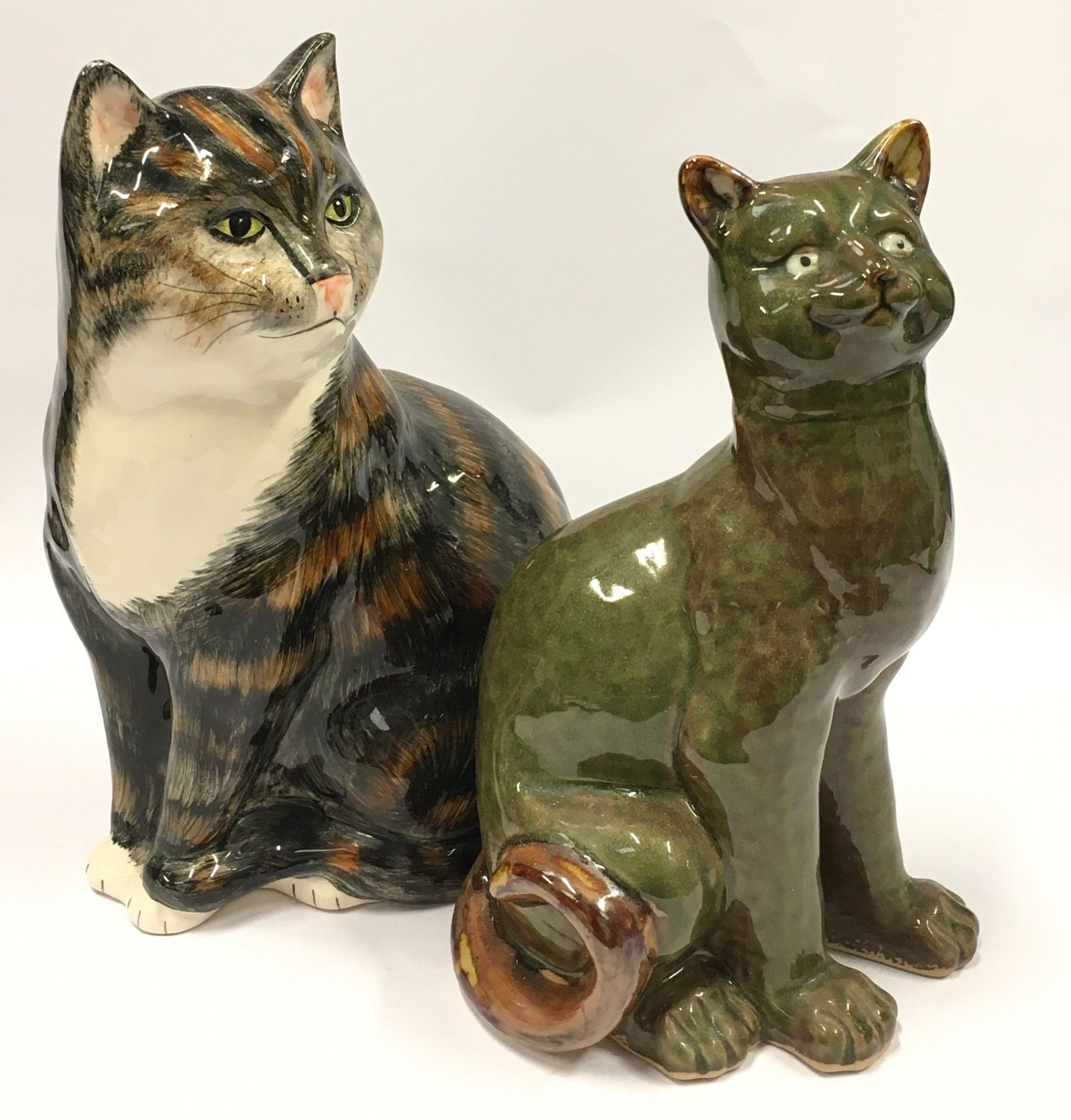 Two ceramic cat figurines the largest measuring 31cm.