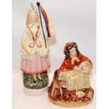 Two antique Staffordshire flatback figures. Patriotic girl holding flag and songbook and Little