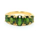 A gold on 925 silver and five stone peridot ring, Size K