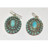 A pair of substantial silver and turquoise drop earrings.