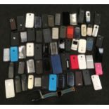 A collection of various mobile phones, iPods and smart watches.