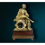 A large 19th century Marti et Cie gilt metal mantle clock. Depicting a seated robed figure on wooden