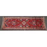 Vintage Mehreben patterned carpet runner on red ground 303x86cm.