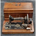 Antique Frister & Rossmann sewing machine in wooden case.