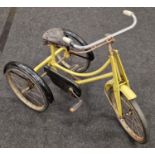 Vintage mid 20th century child's yellow and black painted tricycle.