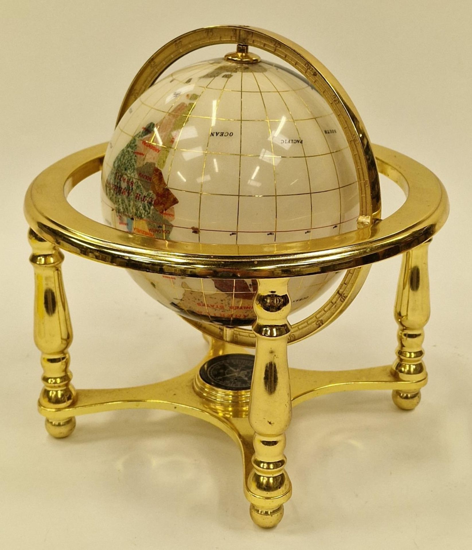 Contemporary gem set revolving globe of the world 24cm tall.