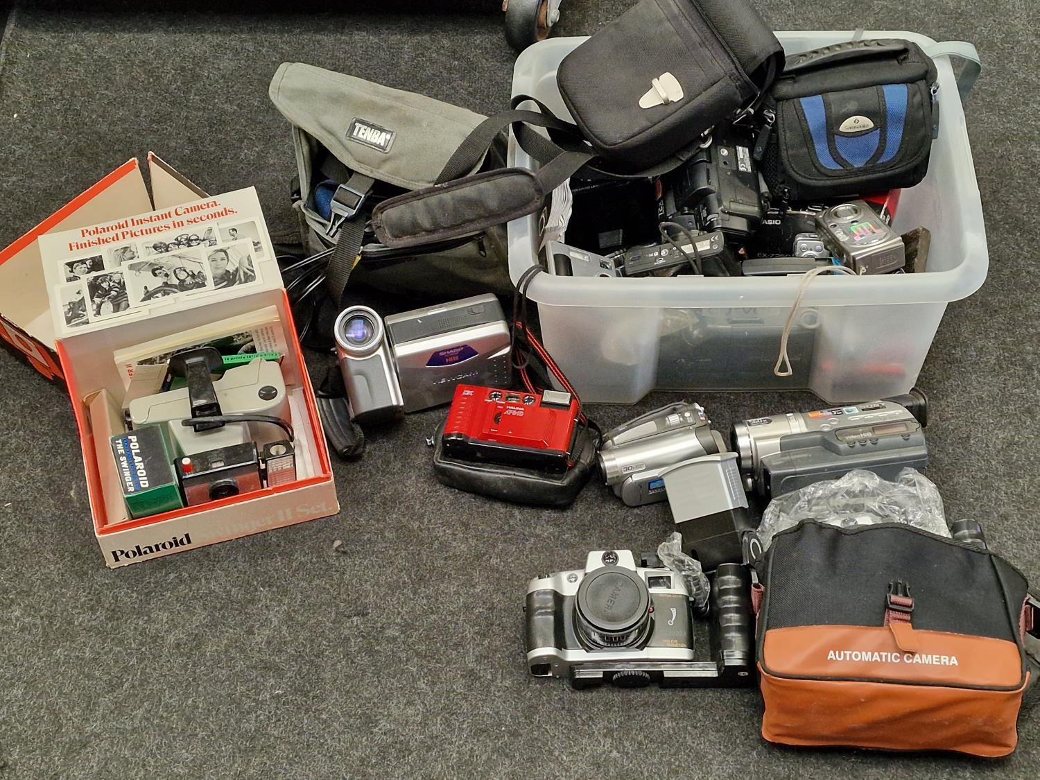 Box containing a large collection of miscellaneous cameras and camcorders.