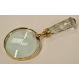 A large brass hand held magnifying glass.