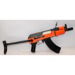 BB gun in the style of an AK47 machine gun. Orange / black two tone body. Untested