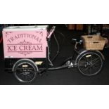 Traditional Ice Cream sales tricycle with ice cream freezer to front and wicker basket to rear.