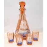 Vintage mid-century peach glass decanter featuring a ship c/w four shot glasses