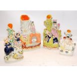 A collection of antique Staffordshire flatback spill vases, the largest being 24cms tall. Four in