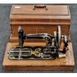 Antique sewing machine in wooden case.