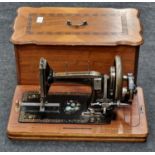 Antique sewing machine in wooden case.