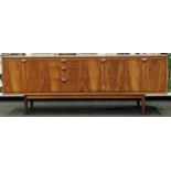Mid century "Austinsuite" low level side board consisting of twin doors, 3 middle draws and drop