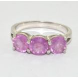 A 925 silver and pink topaz trilogy ring Size N