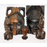 A collection of African carved pieces to include face mask plaques and busts. largest piece is 28cms