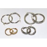 Four pairs of hoop earrings.