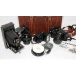 Chinon CM-4 35mm SLR camera c/w lenses and other accessories on a hard travel case together with a