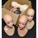 Collection of vintage advertising mannequin heads.