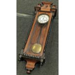 Mahogany wall hanging clock with turned decoration ,pendulum and key 115cm tall roman numeral dial