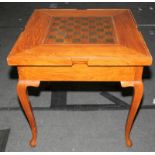 Mahogany turnover top games table on cabriolet legs with fitted games draw