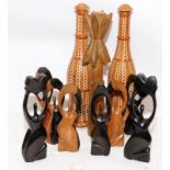 A collection of African carved wooden pieces c/w a pair of wicker covered bottles. Bottles 36cms